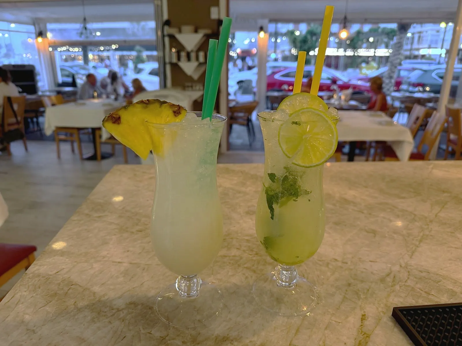 Two long drinks on a marble table on the terrace